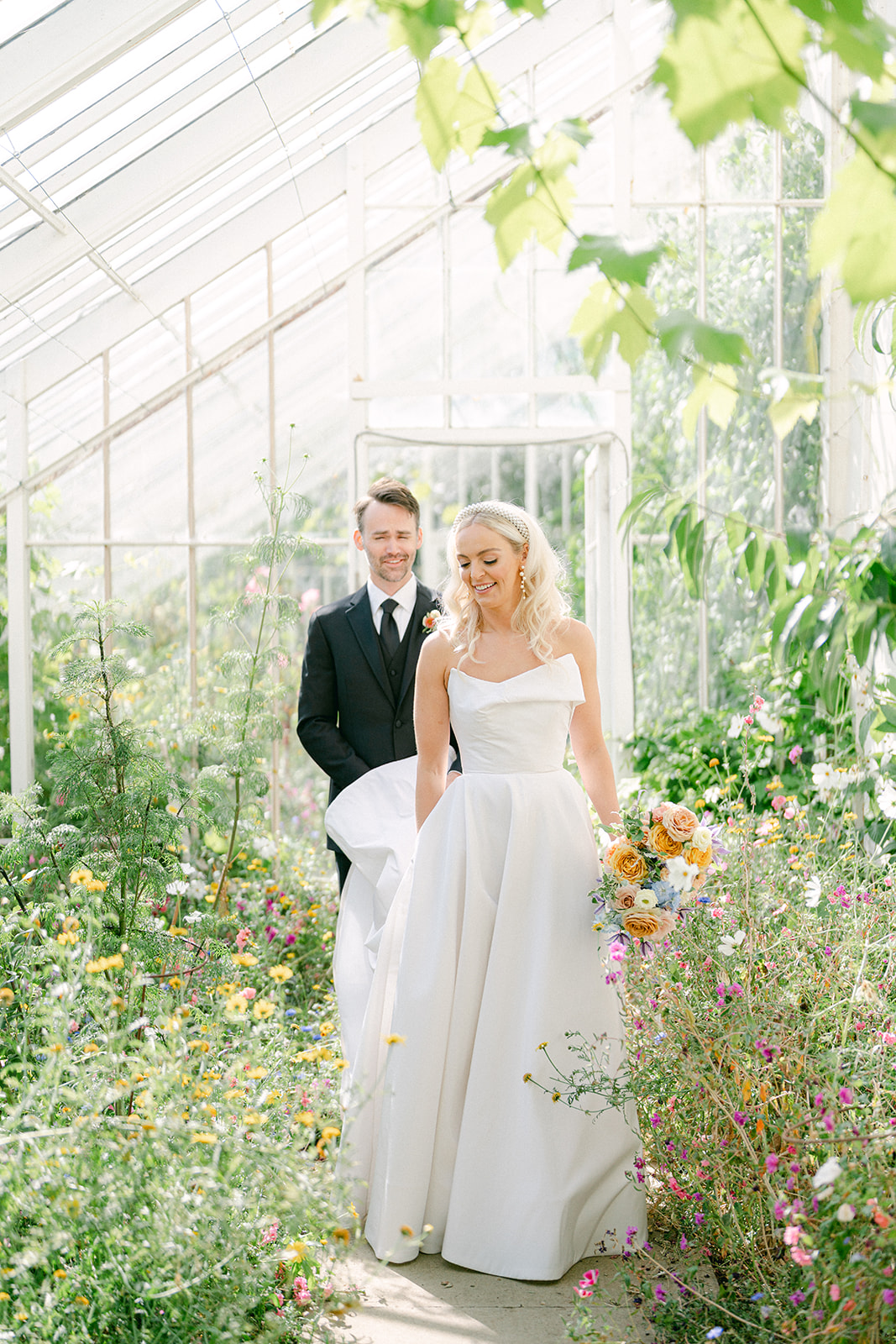 a bride and groom in a greenhouse at their carlowrie castle wedding in scotland